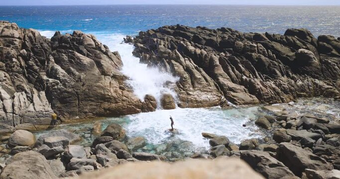 People enjoying injidup natural spa located in Naturaliste area. Tourism and nature, Western Australia. Slow-motion of breaking over rocks.