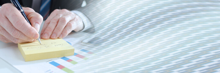 Businessman taking notes; panoramic banner