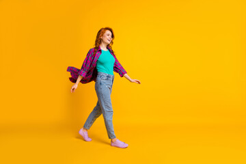 Fototapeta na wymiar Full size profile photo of attractive person walk empty space wear magenta long shirt isolated on yellow color background