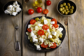 Pasta bows with feta and olives. Italian Cuisine.