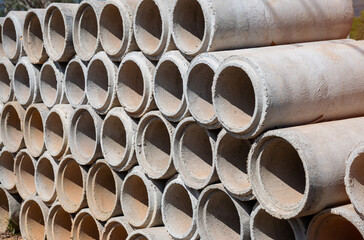 Reinforced concrete pipe for construction,Stacked concrete drainage pipes abstract.