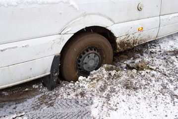 the car stalled in the mud in winter. minivan stalled in the mud. wrong, bad wheel tread for off...