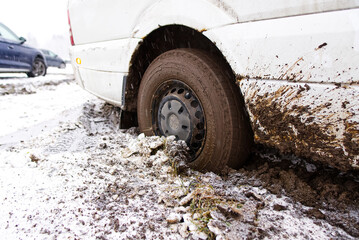 the car stalled in the mud in winter. minivan stalled in the mud. wrong, bad wheel tread for off road