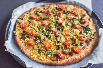 plant-based food, vegan flatbread pizza with cherry tomatoes and dairy-free cheese
