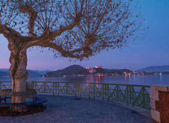 panoramic bench on the lakefront overlooking Angera castle at sunset.panoramic balcony on lake...