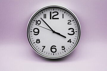 Closeup of retro analog clock on purple background
