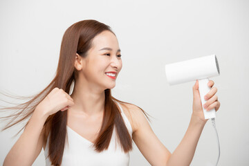 Beautiful Attractive Asian woman smile and holding hair dryer feeling so confident and happiness