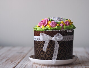 Homemade cakes Easter cake, anointed with cream and roses and decorated with a bow of lace...
