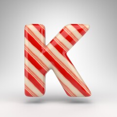 Obraz premium Letter K uppercase on white background. Candy cane 3D letter with red and white lines.
