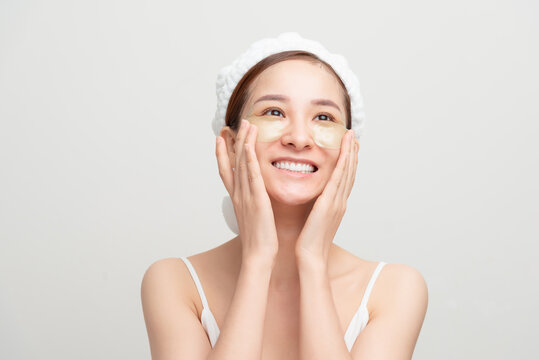 Close-up Of A Young Woman With Patches Under Eyes From Wrinkles And Dark Circles. Isolated On White Background