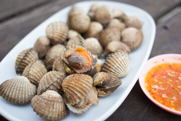 Boiled scallop is served with spicy sauce as a sea food in Thai style.