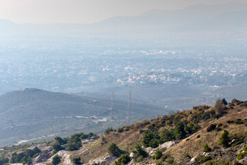 View of columns and power wires and view of the city in the distance (Athens, Greece)