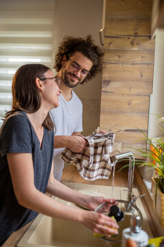 Couple Doing The Washing Up After Lunch Together