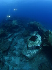 scuba divers exploring airplane wreck underwater taking photos of c47 dakota airplane engine 