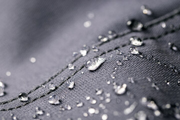 waterproof fabric - closeup of water resistant textile with water drops - obrazy, fototapety, plakaty