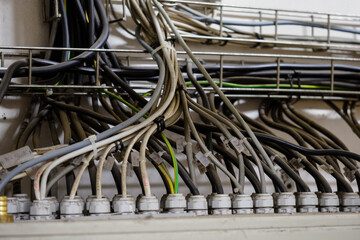 Many cables with plastic gland on top of the cabinet.
