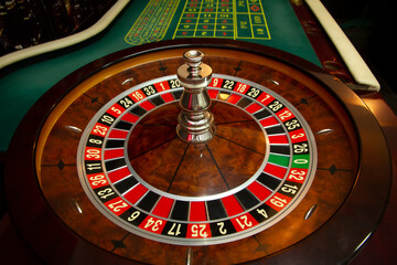 Casino. Drum with numbers. Poker table and card inra