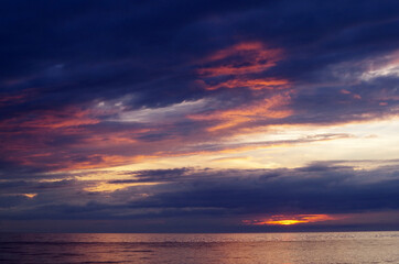 Naklejka na ściany i meble sea sunset with lighted clouds 