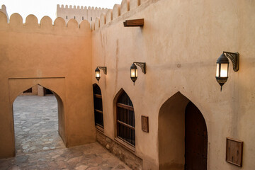 Arches, doors, windows and lamps inside Nizwa Fort. Nizwa, Oman.