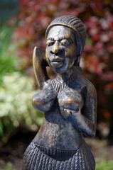 African traditional woman statuette on blur background