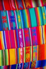 Colorful market with beautiful and unuque handicraft fabric patterns available in Otavalo, Ecuador
