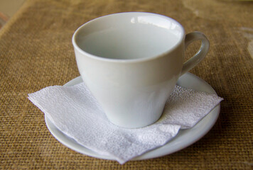 Empty white cup for herbal tea on the table outdoors