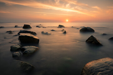 Sunset over the stones on the Baltic Sea