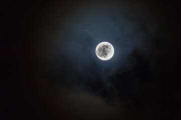 Naklejka na ściany i meble moody clouds illuminated by Full Cold Moon 29th December 2020