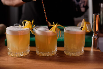 bartender preparing and decorating cocktails at the bar. profession concept