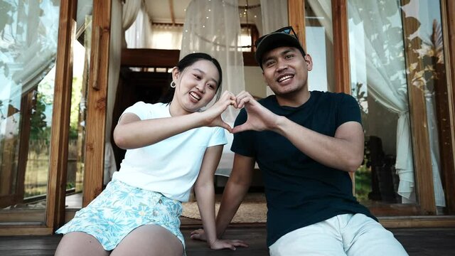 couple hand heart symbol in holiday 