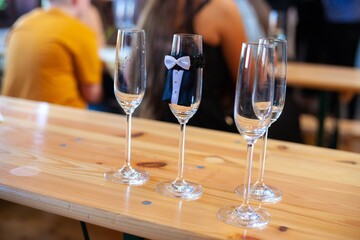 groom's champagne glasses on bar at wedding
