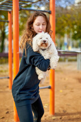 girl doing exercises with a dog in her hands