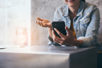 woman work using cell phone hand holding mobile texting message contact us.chatting,search internet information in office.technology device communication connecting