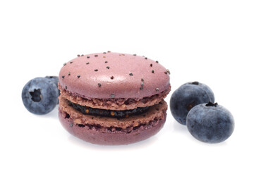 Macaroon with blueberry jam and raw fresh berries isolated on white