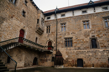 Fortified medieval stronghold, Moated gothic castle at romantic style, National cultural landmark in winter day, Budyne nad Ohri, Northwest Bohemia, Czech Republic