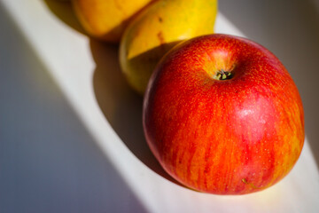 Several red-green apples standing on top of each other