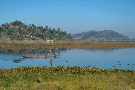 Moirang, India - December 2020: A fisherman with his canoe on Lake Loktak on December 29, 2020 in Moirang, Manipur, India.
