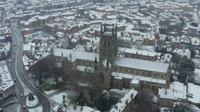 Fly over of city cathedral covered in snow
