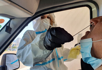 corona drive through covid-19 drive thru testing station man woman in car test for covid infection coronavirus
