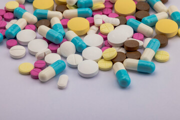 Heap of different pills on white background