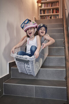 Kids Sledding Down Stairs In A Storage Box