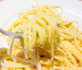 alfredo spaghetti, pasta of the feast in Italy, seasoned with butter, cheese, pepper and herbs