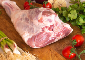 Fresh and raw meat. Leg of lamb on wood background