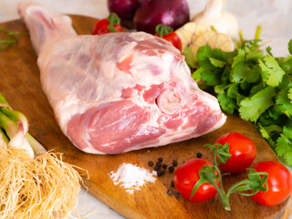 Fresh and raw meat. Leg of lamb on wood background