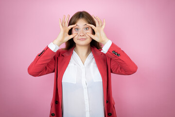 Young business woman over isolated pink background Trying to open eyes with fingers, sleepy and tired for morning fatigue