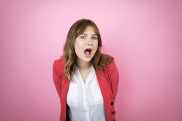 Young business woman over isolated pink background afraid and shocked with surprise and amazed expression, fear and excited face.