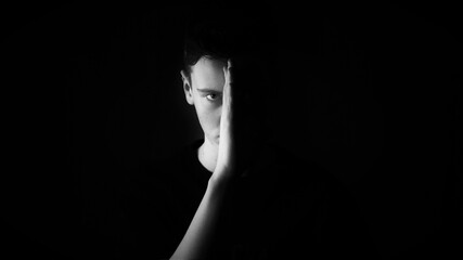 Serious man in black background