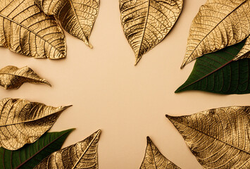 Creative layout made of golden Christmas flower leaves with light brown color paper.