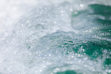 Powerful, stormy, foamy waves are caught up by the wind.