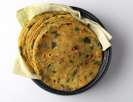 (Thepla) / Indian flat bread,Methi Paratha, Indian flatbread stuffed with fenugreek leaves and spices served with yogurt in breakfast or brunch .
